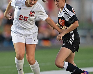 CANFIELD, OHIO - SEPTEMBER 7, 2016: Hannah Stein #25 of Canfield creates space away from Olivia Orr #18 of Howland in the first half of their game Wednesday night at Canfield High School. DAVID DERMER | THE VINDICATOR