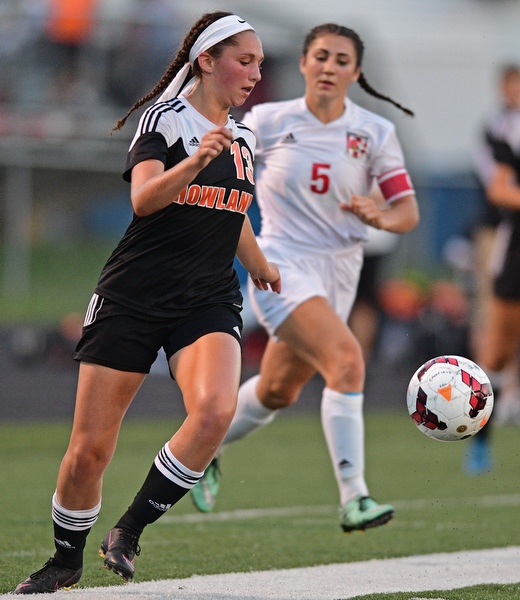CANFIELD, OHIO - SEPTEMBER 7, 2016: Caleigh Hogan #13 of Howland kicks the ball away from Anita Mancini #5 of Canfield in the first half of their game Wednesday night at Canfield High School. DAVID DERMER | THE VINDICATOR
