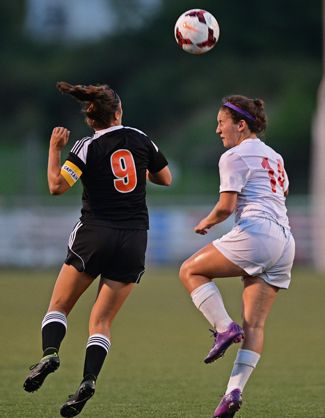 CANFIELD, OHIO - SEPTEMBER 7, 2016: Sara Ciletti #9 of Howland and Alana Petracci #14 of Canfield jump to play the ball in the first half of their game Wednesday night at Canfield High School. DAVID DERMER | THE VINDICATOR