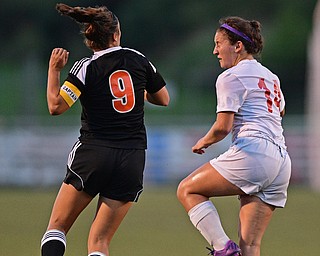 CANFIELD, OHIO - SEPTEMBER 7, 2016: Sara Ciletti #9 of Howland and Alana Petracci #14 of Canfield jump to play the ball in the first half of their game Wednesday night at Canfield High School. DAVID DERMER | THE VINDICATOR