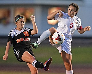 CANFIELD, OHIO - SEPTEMBER 7, 2016: Anita Mancini #5 of Canfield kicks the ball away from Olivia Orr #10 of Howland in the first half of their game Wednesday night at Canfield High School. DAVID DERMER | THE VINDICATOR