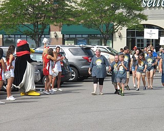 Neighbors | Alexis Bartolomucci.Youngstown State University cheerleaders and Pete the Penguin stood on the sidelines cheering on those who walked in the Buddy Walk on Aug. 13 at the Shops at Boardman.
