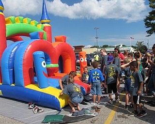 Neighbors | Alexis Bartolomucci.Children lined up after the Buddy Walk on Aug. 13 at the Shops at Boardman to play in the inflatable obstacle course.