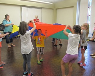Neighbors | Alexis Bartolomucci.Children ran under the parachute when their color was called during story time at the Boardman library on Aug. 17.