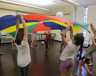 Neighbors | Alexis Bartolomucci.The children put two balls on the parachute that would bounce up and down when they moved the parachute during the Boardman library story time on Aug. 17.