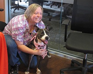 Neighbors | Alexis Bartolomucci.Megan Myers, an animal caretaker, held onto Egypt the dog at Greenbriar during the adoption event on Aug. 21.