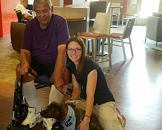 Neighbors | Submitted.Activity director, Meghan Miller, and one of the Greenbriar residents played with Bronson, one of the dogs available for adoption who attended the fundraiser on Aug. 21 at Greenbriar.