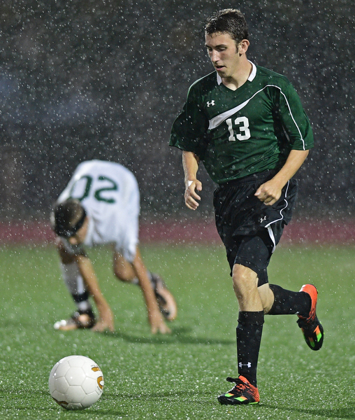 YOUNGSTOWN, OHIO - SEPTEMBER 8, 2016: Ryan Stainer #13 of West Branch dribbles the ball up field during the second half of their game Thursday night at Youngstown State University. DAVID DERMER | THE VINDICATOR..Jacob Coman #20 of Ursuline pictured.
