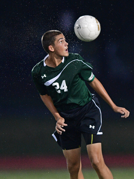 YOUNGSTOWN, OHIO - SEPTEMBER 8, 2016: Connor Hedrick #24 of Ursuline heads the ball after a goalie kick during the second half of their game Thursday night at Youngstown State University. DAVID DERMER | THE VINDICATOR