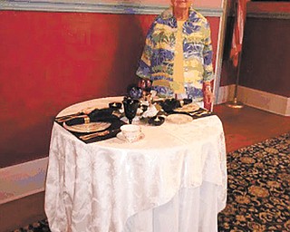 SPECIAL TO THE VINDICATOR
Members of the Upton Association will participate in Warren’s History Hop on Saturday. The History Hop will take participants to several historic locations in downtown Warren by trolley. The locations include four homes, the Robins Theater, Speakeasy Lounge, the oldest bar and the oldest restaurant in Warren. They will be open for tours to promote the history of the business or organization. The Harriet Taylor Upton House will be open Sept. 25 for the Warren Homecoming event as well as several historic homes. Dotty Sabey, above, checks her place setting display at a recent gold place settings event at the Upton House.
