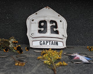 Nikos Frazier | The Vindicator..A badge from a fire fighter's helmet sits on the wall seperating the public and the final resting place for the 40 passengers and crew aboard United Flight 93.