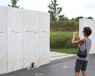 Nikos Frazier | The Vindicator..Karen Kretschmann of Greensburg, Ind. takes a photo of the memorial wall at the Flight 93 National Memorial in Shanksville, Pa.
