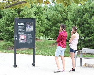 Nikos Frazier | The Vindicator..Sisters, Victoria and Mary Hessler of Maryland read about the heroes of United Flight 93 on Aug. 8, 2016.