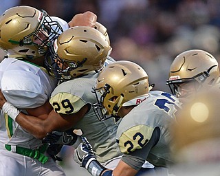 AKRON, OHIO - SEPTEMBER 9, 2016: Spencer Warren #44 of Ursuline is stood up inside the 10 yard line by Arison Sanders #29, Matt Salopek #22 and other Hoban defenders during the first half of their game Friday night at Hoban High School. DAVID DERMER | THE VINDICATOR