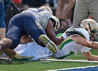 AKRON, OHIO - SEPTEMBER 9, 2016: Quarterback Jared Fabry #13 of Ursuline reaches the ball out while being knocked out at the one yard line by Arison Sanders #29 of Hoban during the first half of their game Friday night at Hoban High School. DAVID DERMER | THE VINDICATOR
