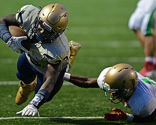 AKRON, OHIO - SEPTEMBER 9, 2016: Running back Todd Sibley #23 of Hoban falls forward after being knocked off balance by Dakota Hobbs #14 of Ursuline during the first half of their game Friday night at Hoban High School. DAVID DERMER | THE VINDICATOR