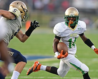 AKRON, OHIO - SEPTEMBER 9, 2016: Dakota Hobbs #14 of Ursuline looks for space around the outside while being chased down by Nate Bauer #5 of Hoban during the first half of their game Friday night at Hoban High School. DAVID DERMER | THE VINDICATOR