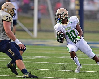 AKRON, OHIO - SEPTEMBER 9, 2016: Dawalyn Washington #10 of Ursuline runs with the football after a interception while being chased by Marc Westover #50 of Hoban during the first half of their game Friday night at Hoban High School. DAVID DERMER | THE VINDICATOR