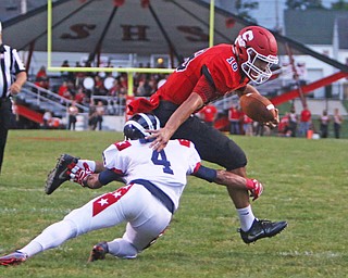 Struthers quarterback AJ Musolino (18) avoids a tackle by Tre Martin (4) of Niles while on his way to the endzone during the first quarter of Friday nights matchup at Struthers High School.  Dustin Livesay  |  The Vindicator  9/9/16  Struthers.