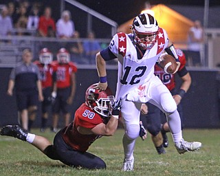 Jordan Soda (12) of Niles gets sacked by Jeff Bloomberg (50) of Struthers during the third quarter of Friday nights matchup at Struthers High School.  Dustin Livesay  |  The Vindicator  9/9/16  Struthers.