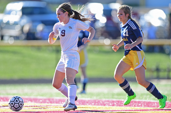 CANFIELD, OHIO - SEPTEMBER 12, 2016: Casey Windstorm #9 of South Range kicks the ball into the back of the net to score her 100th career goal after getting behind defender Allison Zepernick #21of United during the first half of their game Monday night at South Range High School. DAVID DERMER | THE VINDICATOR