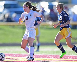 CANFIELD, OHIO - SEPTEMBER 12, 2016: Casey Windstorm #9 of South Range kicks the ball into the back of the net to score her 100th career goal after getting behind defender Allison Zepernick #21of United during the first half of their game Monday night at South Range High School. DAVID DERMER | THE VINDICATOR