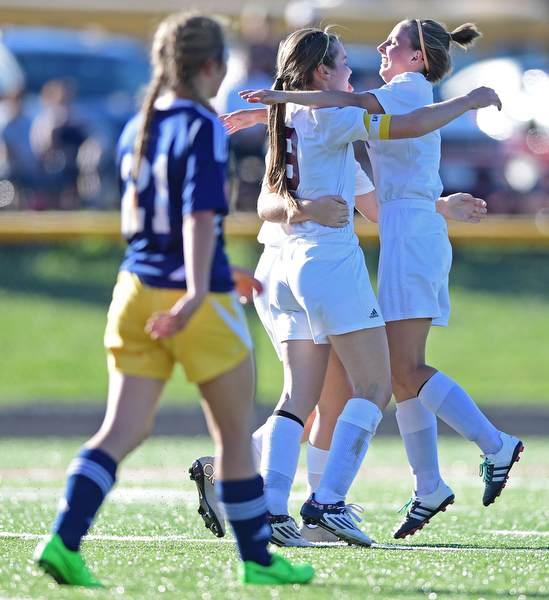 CANFIELD, OHIO - SEPTEMBER 12, 2016: Casey Windstorm #9 of South Range is hugged by her teammates Caragyn Yanek #10 and Lillian Kimpel #3 after scoring her 100th career goal during the first half of their game Monday night at South Range High School. DAVID DERMER | THE VINDICATOR..Allison Zepernick #21of United pictured.