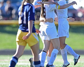 CANFIELD, OHIO - SEPTEMBER 12, 2016: Casey Windstorm #9 of South Range is hugged by her teammates Caragyn Yanek #10 and Lillian Kimpel #3 after scoring her 100th career goal during the first half of their game Monday night at South Range High School. DAVID DERMER | THE VINDICATOR..Allison Zepernick #21of United pictured.