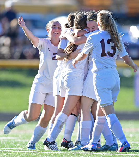 CANFIELD, OHIO - SEPTEMBER 12, 2016: Casey Windstorm #9 of South Range is hugged by her teammates Caragyn Yanek #10, Lillian Kimpel #3, Jillian Maynard and Abbey Bokros #13 during the first half of their game Monday night at South Range High School. DAVID DERMER | THE VINDICATOR.