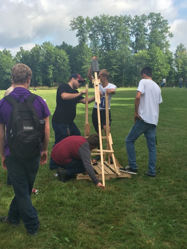 Neighbors | Submitted.Students working together to get the trebuchet ready for launch.