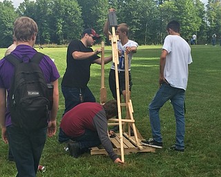 Neighbors | Submitted.Students working together to get the trebuchet ready for launch.