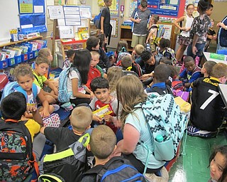 Neighbors | Alexis Bartolomucci.Fourth-grade students and kindergarten students sat together at the end of the day on Sept. 1 at Robinwood Lane Elementary before the older students walked the younger students to their busses.