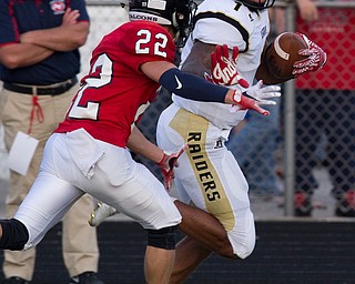 MICHAEL G TAYLOR | THE VINDICATOR- 9-16-16- 1st half., Austintiown's #22 JC Mikovich (left) is stiiffed armed by Harding's #1 Lynn Bowden during his 1st qtr TD run. Warren G. Harding Raiders vs Austintown Fith Falcons at Falcon Stadium in Austintown, OH.