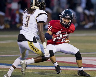 MICHAEL G TAYLOR | THE VINDICATOR- 9-16-16- 2nd qtr., Austintiown's #22 JC Mikovich (left) cuts up field against Harding's #3 Tavon Hooks. Warren G. Harding Raiders vs Austintown Fith Falcons at Falcon Stadium in Austintown, OH.