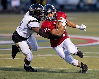MICHAEL G TAYLOR | THE VINDICATOR- 9-16-16- 2nd qtr., Austintiown's #25 Randy Smith (right) cuts up field against Harding's #4 Thad McCollough. Warren G. Harding Raiders vs Austintown Fith Falcons at Falcon Stadium in Austintown, OH.