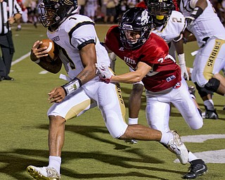 MICHAEL G TAYLOR | THE VINDICATOR- 9-16-16- 3rd qtr., Austintiown's #22 JC Mikovich (right) bring down Harding's #1 Lynn Bowden. Warren G. Harding Raiders vs Austintown Fith Falcons at Falcon Stadium in Austintown, OH.