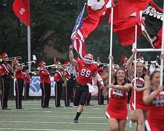 Nikos Frazier | The Vindicator..Shane Kuhn(86) charges into Stambaugh Stadium with an American Flag before the Youngstown State Penguins took on the Robert Morris Colonials on Saturday, Sept. 17, 2016.