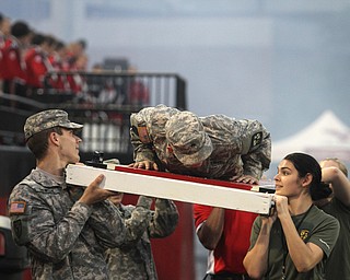 Nikos Frazier | The Vindicator..Matthew Gamble, a junior at Youngstown State, does 24 pushups on a platform carried by fellow ROTC students at Stambaugh Stadium on Saturday, Sept. 17, 2016..