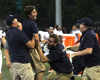 Nikos Frazier | The Vindicator..Robert Morris football staff celebrate after the Colonials' first touchdown against Younstown State at Stambaugh Stadium on Saturday, Sept. 17, 2016.