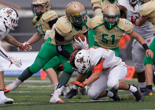 MICHAEL G TAYLOR | THE VINDICATOR- 9-17-16- 1st qtr., after picking up the 1st down, Ursuline's #7 Joe Floyd is tackled by Massillon's #32 Kordell Ford. Massillon-Washington Tigers vs Youngstown Ursuline Irish at Mollenkopf Stadium in Warren, OH.