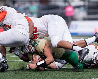 MICHAEL G TAYLOR | THE VINDICATOR- 9-17-16- 1st qtr., Ursuline's #13 Jared Fabry is bowled over by  Massillon's #40 Noah Baltzer (right) and #32 Kordell Ford. Massillon-Washington Tigers vs Youngstown Ursuline Irish at Mollenkopf Stadium in Warren, OH.