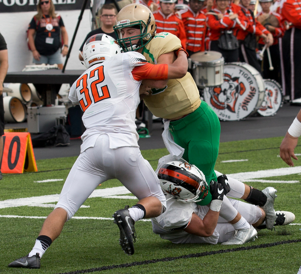 MICHAEL G TAYLOR | THE VINDICATOR- 9-17-16- Late 2nd qtr., Ursuline's #13 Jared Fabry is stopped by  Massillon's #4 Jacob Risher and #32 Kordell Ford on the 3 yardline. Massillon-Washington Tigers vs Youngstown Ursuline Irish at Mollenkopf Stadium in Warren, OH.