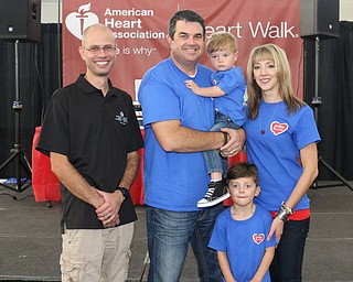 Heart walk director Brian Duchan poses for a picture with Heart Walk chairman Kevin Helmick and his family Spencer (2), Amie, and Preston (5) before the start of the Heart Walk at the WATTS on the campus of Youngstown State University on Saturday morning. Dustin Livesay  |  The Vindicator  9/17/16  WATTS