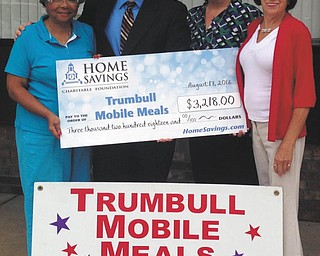 SPECIAL TO THE VINDICATOR
The Home Savings Charitable Foundation recently donated $3,218 to Trumbull Mobile Meals to fund the purchase of an automatic meat and vegetable slicer. Gussie Reed, left, vice chairwoman of the board for TMM, received the check from Andrew Nemergut, retail manager of Home Savings Eastwood office, with Rebecca Edwards, CEO of TMM, and Barbara Petiya, grant writer for TMM. The mission statement of Mobile Meals is “No person goes hungry.” The organization is dedicated to serving those in need who cannot drive to a meal site or food distribution center. For information on TMM, call 330-394-2538 or visit www.trumbullmobilemeals.org.