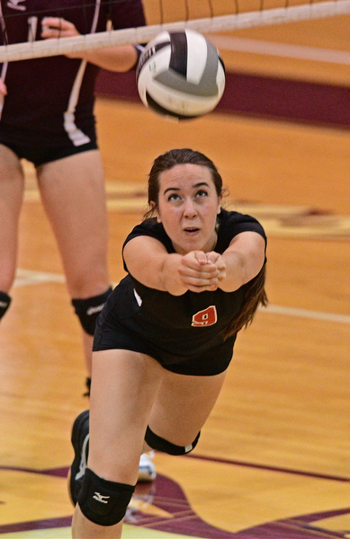 BOARDMAN, OHIO - SEPTEMBER 20, 2016: Jenny Smith #9 of Canfield falls to the ground while keeping the ball alive during the first set of their match Tuesday night at Boardman High School. DAVID DERMER | THE VINDICATOR