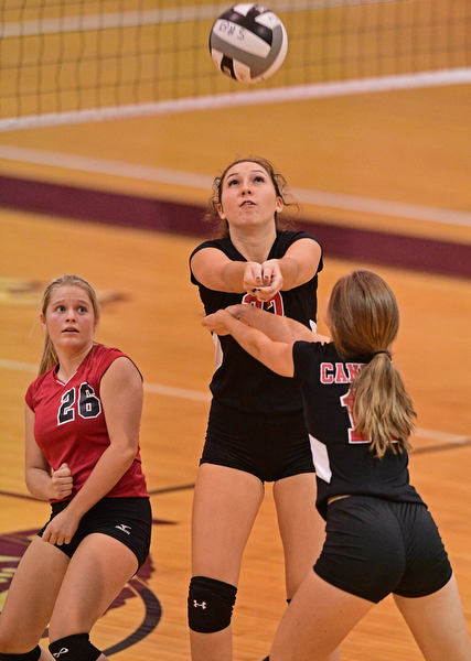 BOARDMAN, OHIO - SEPTEMBER 20, 2016: Jenna Varley #27 of Canfield (center) bumps the ball while avoiding teammates Jessica Meissner #26 (left) and Emilie Miasek #12 (right) during the first set of their match Tuesday night at Boardman High School. DAVID DERMER | THE VINDICATOR