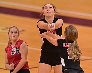 BOARDMAN, OHIO - SEPTEMBER 20, 2016: Jenna Varley #27 of Canfield (center) bumps the ball while avoiding teammates Jessica Meissner #26 (left) and Emilie Miasek #12 (right) during the first set of their match Tuesday night at Boardman High School. DAVID DERMER | THE VINDICATOR