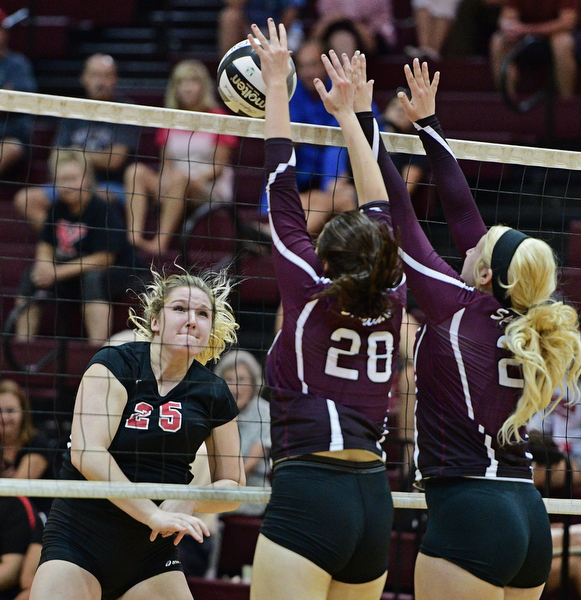 BOARDMAN, OHIO - SEPTEMBER 20, 2016: Madison Johns #25 of Canfield watches the ball go over the net while Kristen Bean #28 and Lindsay Tomcsanyi #21 of Boardman go for the block during the third set of their match Tuesday night at Boardman High School. DAVID DERMER | THE VINDICATOR