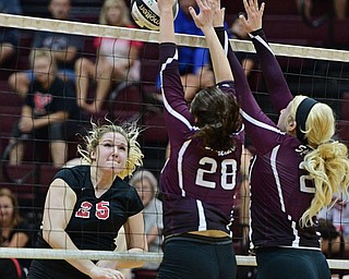 BOARDMAN, OHIO - SEPTEMBER 20, 2016: Madison Johns #25 of Canfield watches the ball go over the net while Kristen Bean #28 and Lindsay Tomcsanyi #21 of Boardman go for the block during the third set of their match Tuesday night at Boardman High School. DAVID DERMER | THE VINDICATOR
