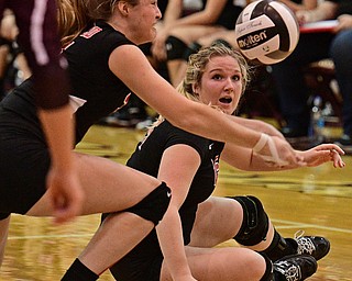 BOARDMAN, OHIO - SEPTEMBER 20, 2016: Madison Johns #25 of Canfield watches the ball fall toward the ground while teammate Natalie Maras #31 keeps the ball alive during the third set of their match Tuesday night at Boardman High School. DAVID DERMER | THE VINDICATOR